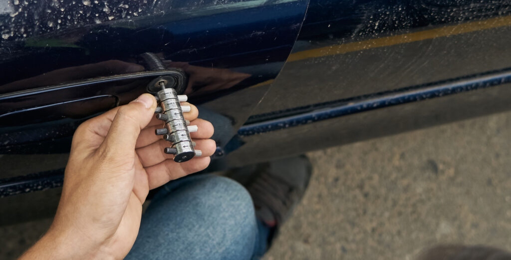 24/7 Locksmith West Highlands: A locksmith working on a car key replacement late at night in West Highlands, Winston-Salem, NC. Affordable Car Keys is always available.